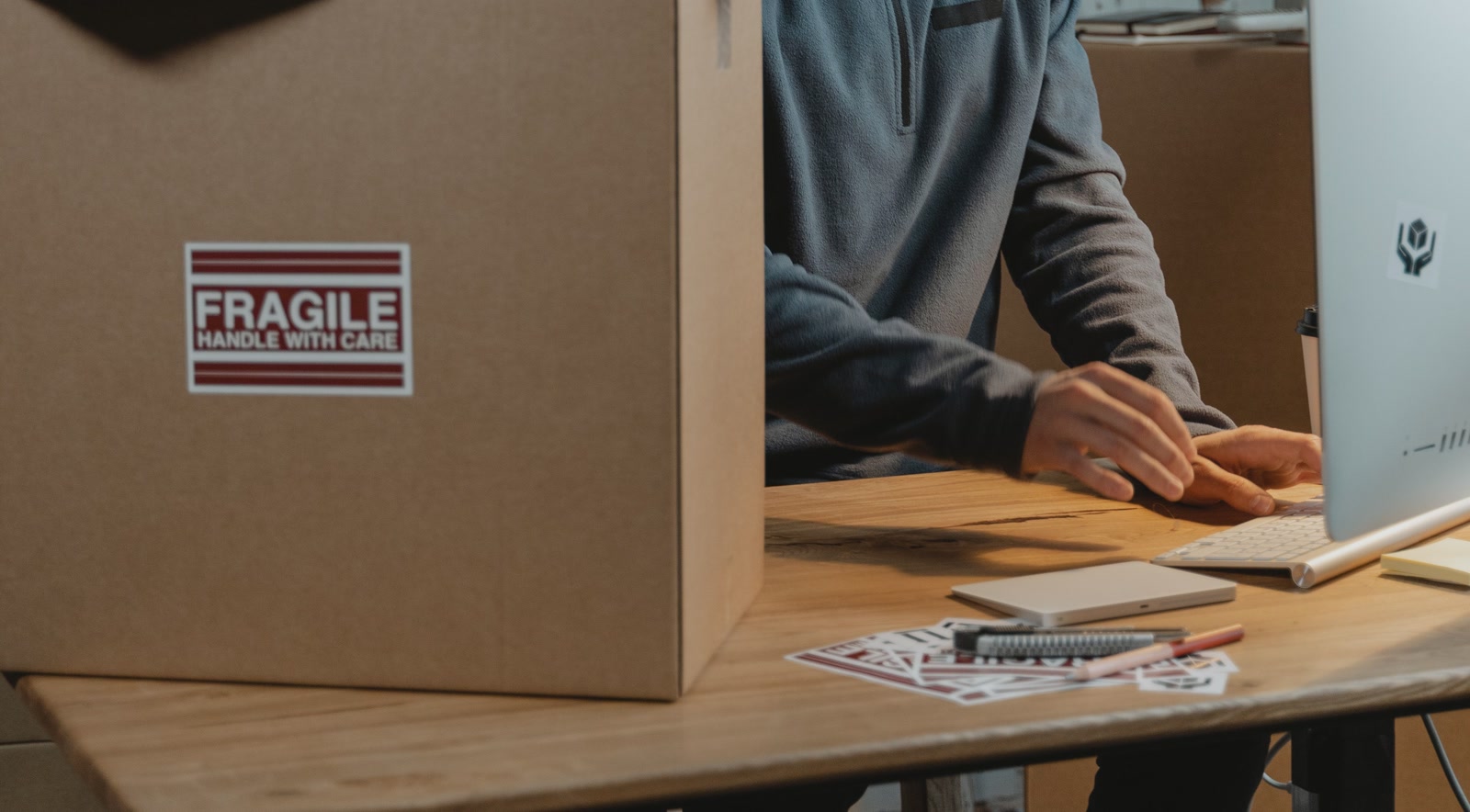 Shopify order fulfilment workspace with parcels and a desktop computer